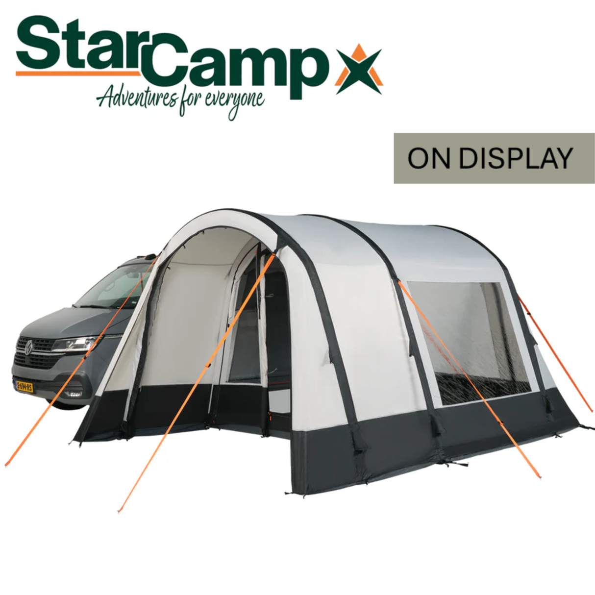 Dorema StarCamp Voyager Air Driveaway Awning set up beside a camper, showcasing its spacious design and durable material.