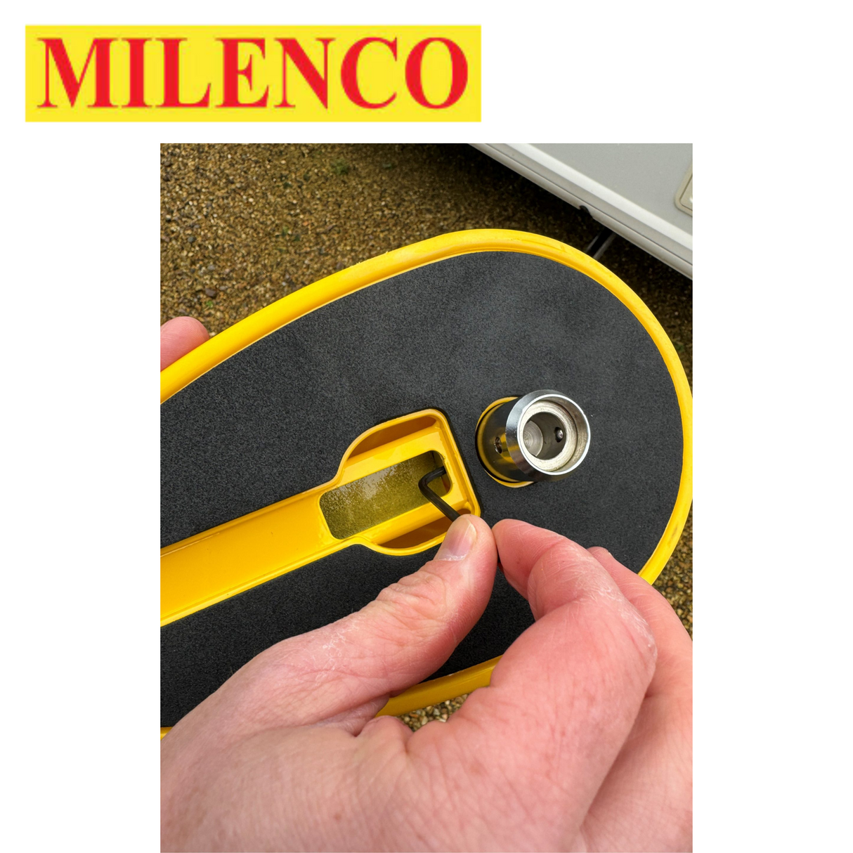 Milenco Wraith 3 Caravan Wheel Lock securely fits around a caravan wheel, featuring a bright yellow and black design.