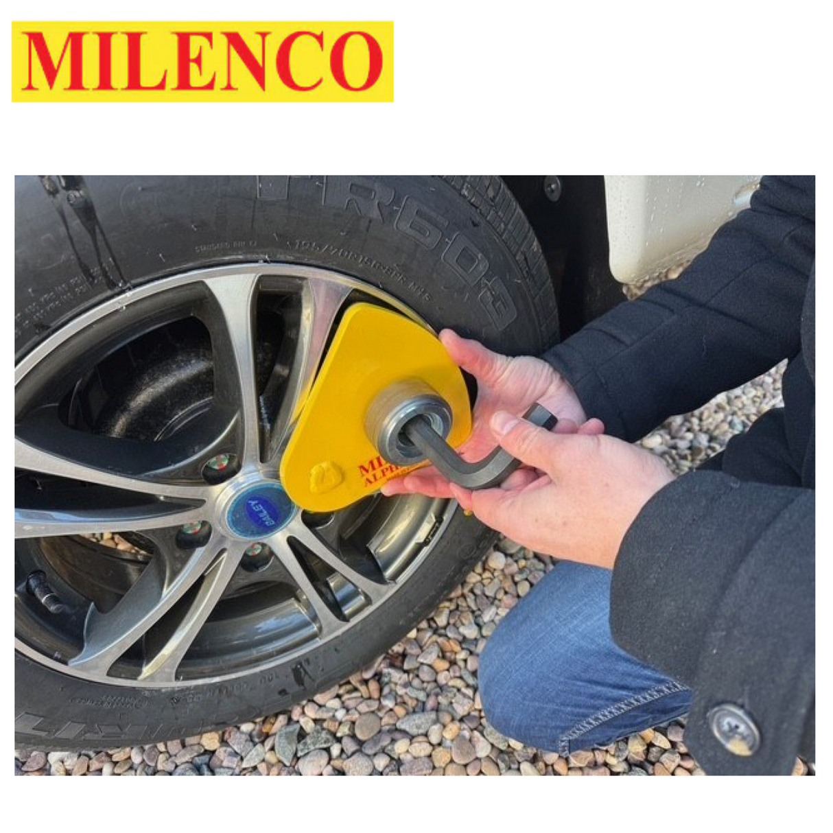 Milenco Alpha Gold Wheel Lock secured on a wheel, showcasing its durable design and bright yellow color.