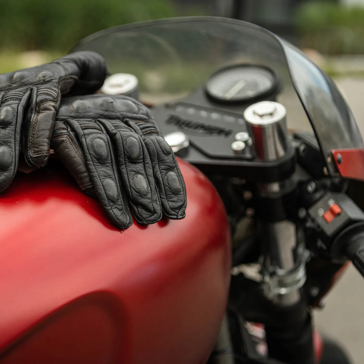 Autoglym Motorcycle Cleaner bottle on a surface, showcasing its label and spray nozzle for easy application.