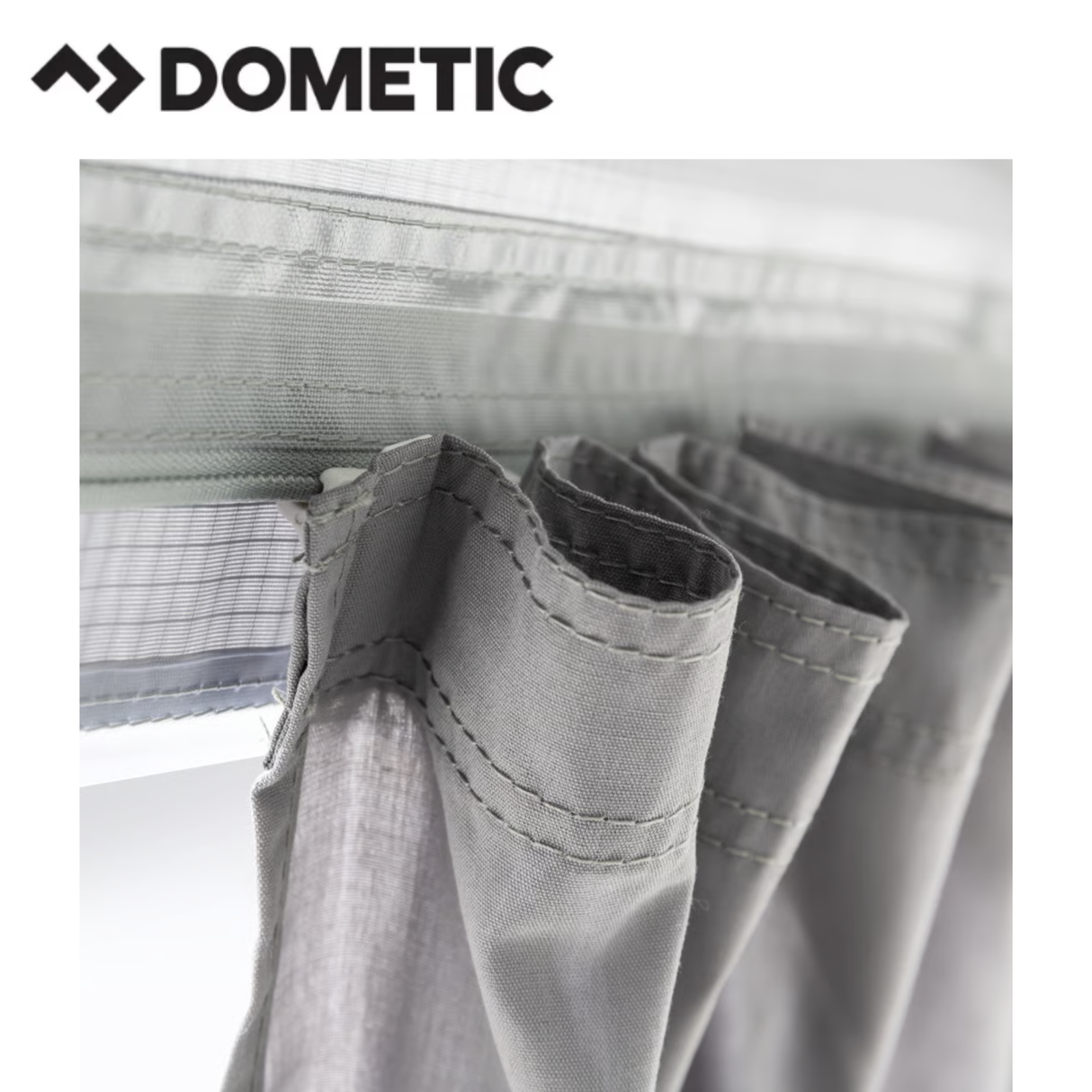 Dometic Rally Air Stay 260s awning attached to a camper, showcasing its fabric, support arms, and attachment points.