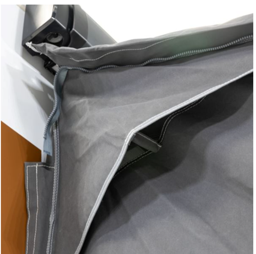 Dometic Grande Air All Season 390 Awning, a spacious air awning set up beside a camper in a scenic outdoor setting.