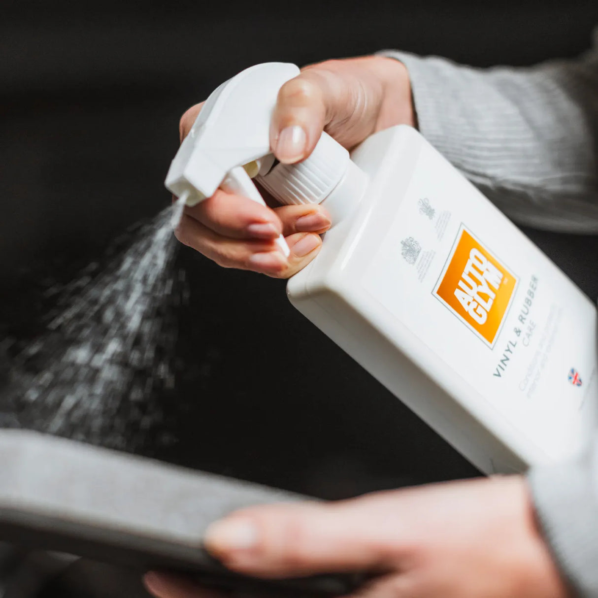 Autoglym Vinyl & Rubber Care cleaner bottle on a surface, designed for maintaining vehicle vinyl and rubber surfaces.