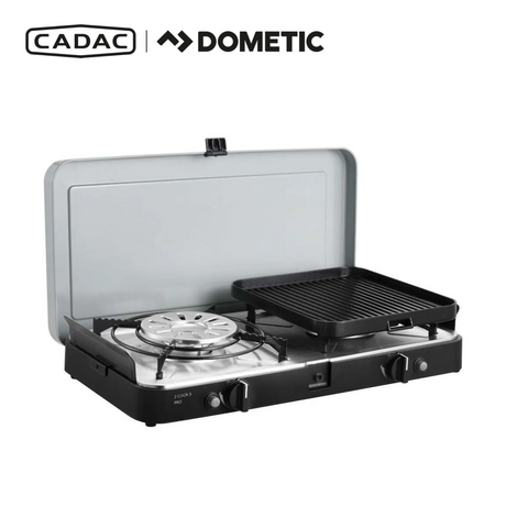 Cadac Dometic 2 Cook 3 Pro Deluxe QR gas BBQ with dual burners and sturdy legs in outdoor setting.