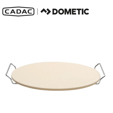 Cadac Dometic 33cm pizza stone for even baking, shown on a countertop with a textured surface and prepared for use.