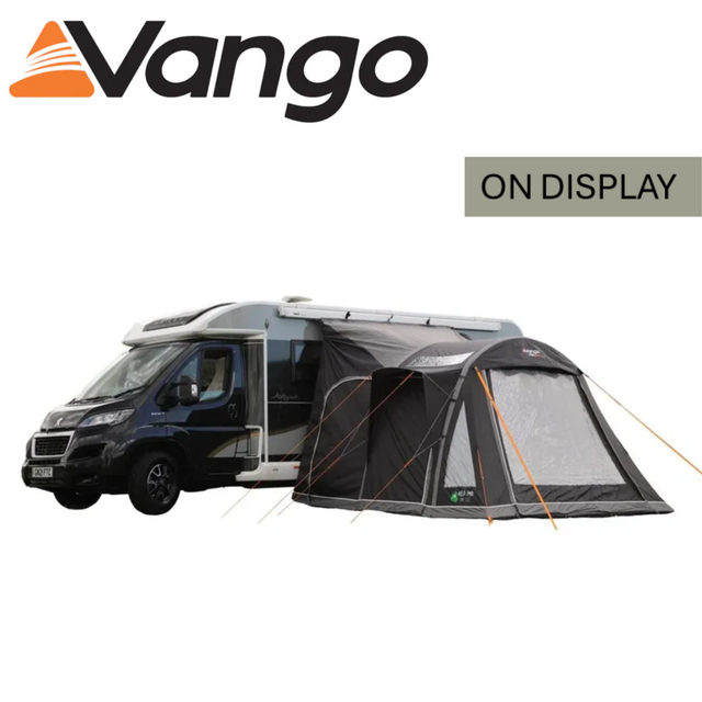 Vango Kela Pro Air Tall Driveaway Awning set up beside a camper van, showcasing its spacious interior and durable design.