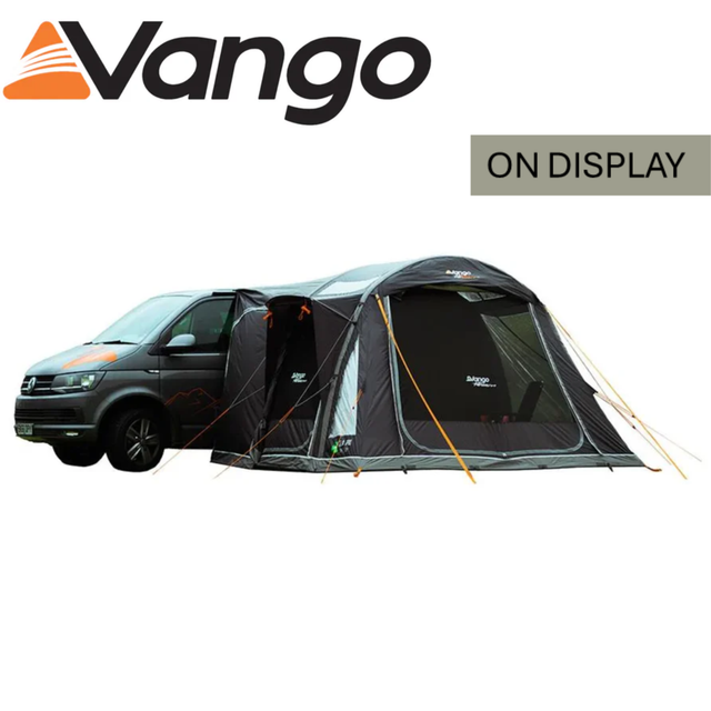 Vango Kela Pro Air Low Driveaway Awning set up beside a campervan, showcasing its spacious design and sturdy structure.