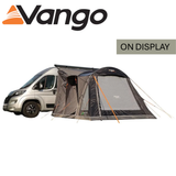 Vango Kela Pro Air Mid Driveaway Awning set up beside a campervan, showcasing its spacious design and air beam structure.