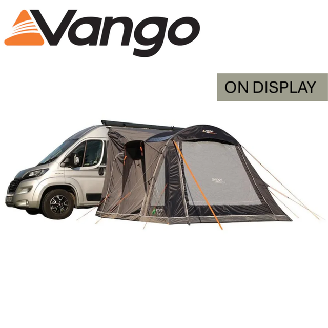 Vango Kela Pro Air Mid Driveaway Awning set up beside a campervan, showcasing its spacious design and air beam structure.