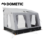 Dometic Rally Air Tour 390 air awning attached to a camper, showcasing its fabric canopy and air frame for outdoor camping.