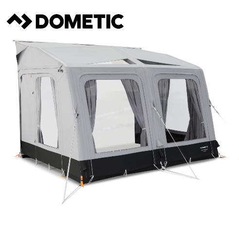 Dometic Rally Air Tour 390 air awning attached to a camper, showcasing its fabric canopy and air frame for outdoor camping.