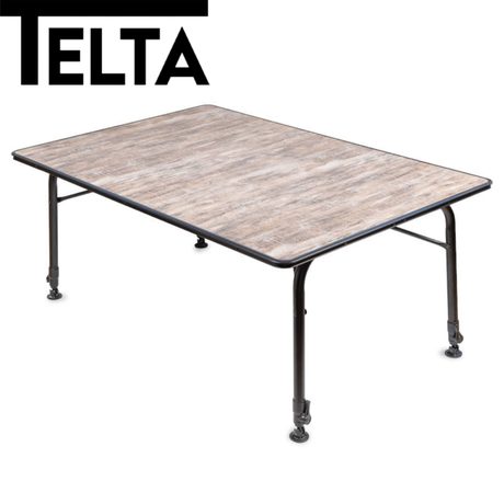 Telta Bornholm large camping table set up outdoors with a picnic spread, showcasing its sturdy design and spacious surface.