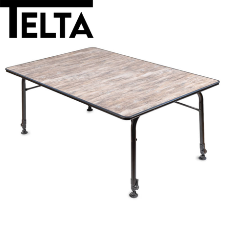 Telta Bornholm medium camping table set up outdoors with a scenic background, showcasing its sturdy design and surface.