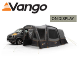 Vango Versos Air Low Driveaway Awning in a campsite setting, showcasing its spacious design and attached to a vehicle.