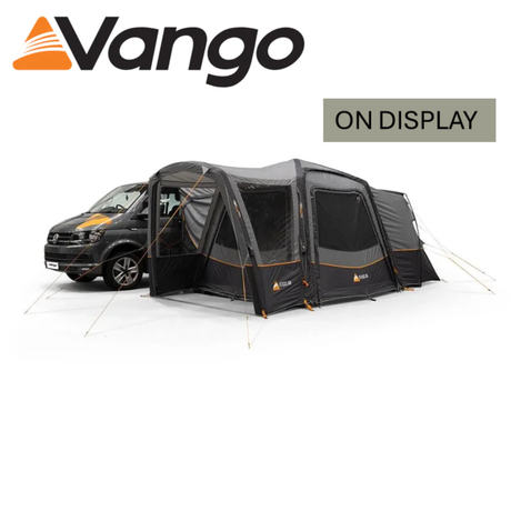 Vango Versos Air Low Driveaway Awning in a campsite setting, showcasing its spacious design and attached to a vehicle.