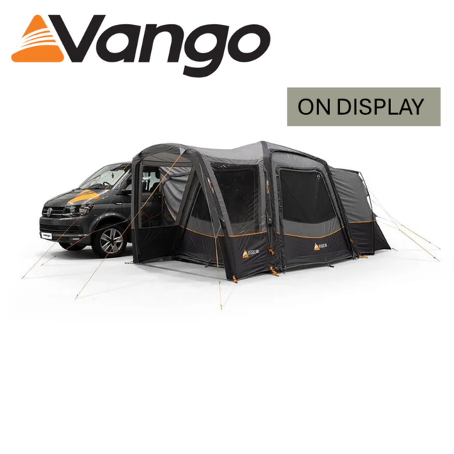 Vango Versos Air Low Driveaway Awning in a campsite setting, showcasing its spacious design and attached to a vehicle.