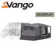 Vango Versos Air Mid Driveaway Awning set up beside a campervan, showcasing spacious design and airy fabric structure.