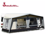 Isabella Ambassador Dawn All Season Touring Awning attached to a camper, showcasing its fabric and frame setup for outdoor camping.
