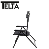 Telta Anholt reclining chair with plush cushioning and wooden armrests, shown in a relaxed seated position.