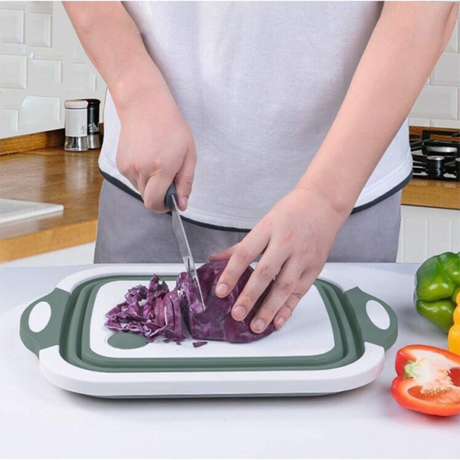 Pack and Go collapsible sink with cutting board, portable kitchen basin for camping or travel, shown folded and in use.