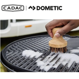 Cadac Dometic GreenGrill Brush with green handle and bristles, designed for cleaning ceramic grill surfaces effectively.