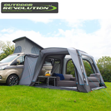Outdoor Revolution Cayman Air High Driveaway awning set up outside a tent, showcasing its spacious, high-driveaway design for camping.