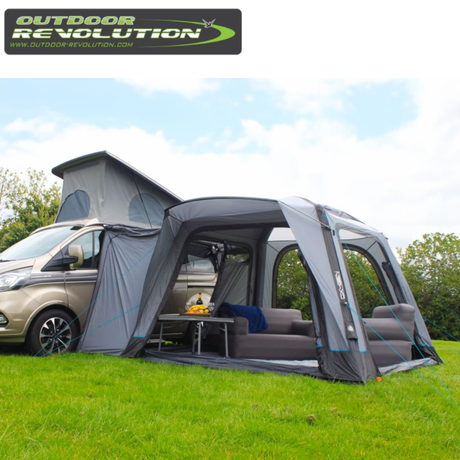 Outdoor Revolution Cayman Air High Driveaway awning set up outside a tent, showcasing its spacious, high-driveaway design for camping.