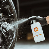 Autoglym Clean Wheels vehicle cleaner in a spray bottle with a label featuring the brand logo and cleaning instructions.