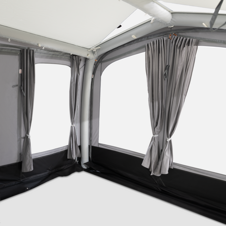 Dometic Club Air Tour 260 driveaway awning set up beside a van, showcasing its spacious design and durable fabric.
