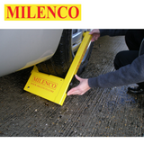 Milenco Compact Wheel Clamp 2745 securely fits over a wheel, featuring a bright yellow design for visibility and security.
