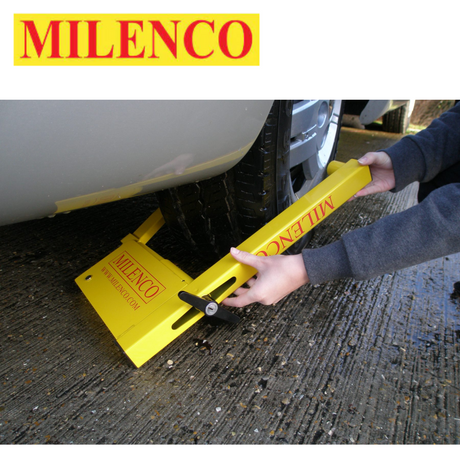 Milenco Compact Wheel Clamp - model 2745 securely fastened to a wheel, showcasing its robust design and bright color.