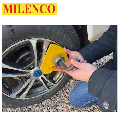 Milenco Alpha Gold Wheel Lock secured on a wheel, showcasing its durable design and bright yellow color.