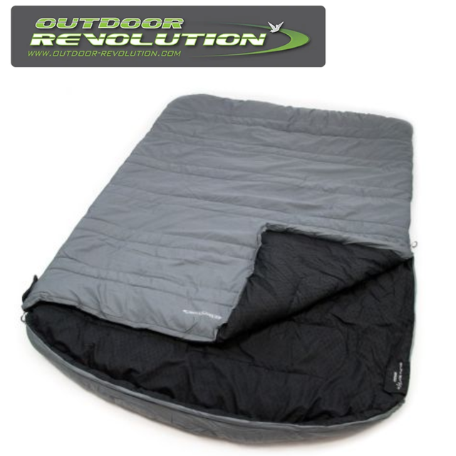 Outdoor Revolution SunStar Double 300 sleeping bag in a cozy, zipped position on a grassy outdoor surface.