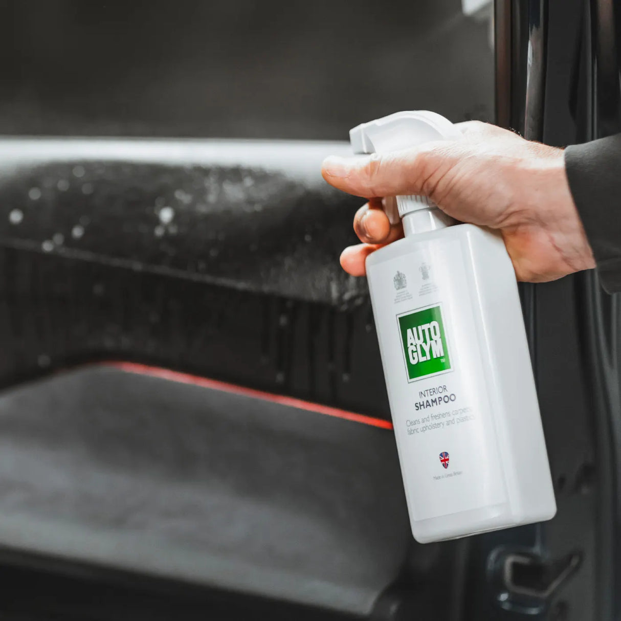 Autoglym Interior Shampoo bottle with spray nozzle, designed for cleaning vehicle interiors effectively.