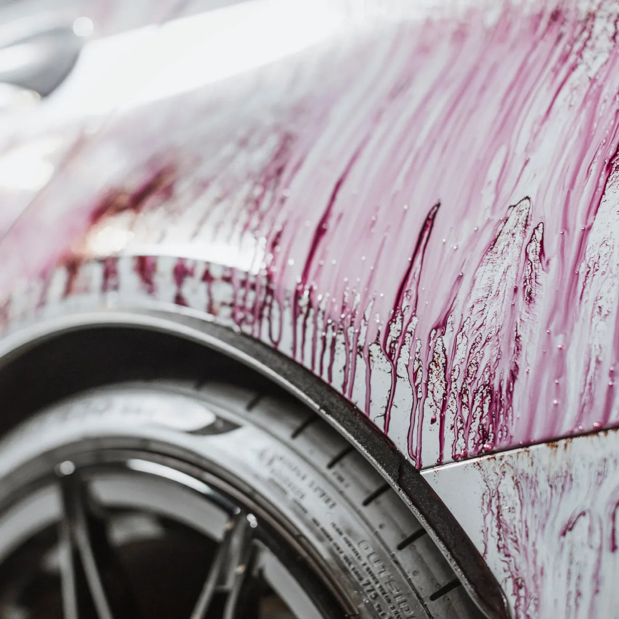 Autoglym Magma vehicle cleaner bottle with vibrant red liquid and spray nozzle on a white background.
