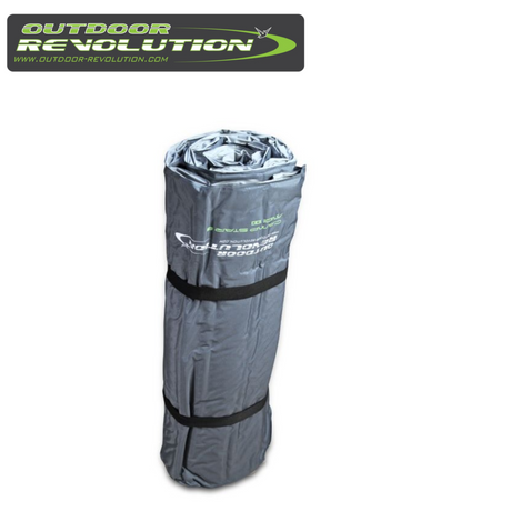 Outdoor Revolution Camp Star Midi 100 self-inflating mat laid out on grass, showcasing its texture and thickness.