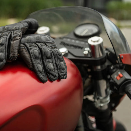 Autoglym Motorcycle Cleaner bottle on a surface, showcasing its label and spray nozzle for easy application.