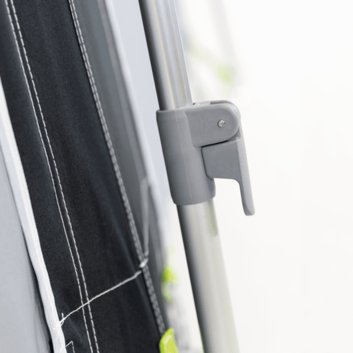 Dometic Rally Tour poled awning with sturdy poles set up for outdoor use, showcasing its spacious canopy and design.