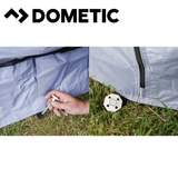Dometic Pro Organiser Shirt awning skirt hanging outdoors, showing fabric and attachment details in a natural setting.