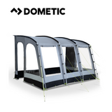 Dometic Rally poled awning set up outdoors, showcasing its sturdy poles and spacious canopy for camping use.