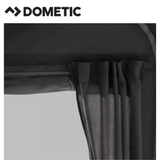 Dometic Residence Air Stay awning attached to a camper, providing shaded outdoor space with fabric and support poles.