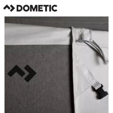 Dometic Stuga Rest Awning extended on a camper, providing shaded outdoor space with durable fabric and sturdy support poles.