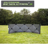 Outdoor Revolution Pronto Tensile Active 4 Panel Windbreak set up in a grassy area, providing shelter from the wind.