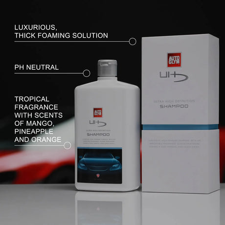 Autoglym UHD Shampoo bottle with a sleek design, surrounded by bubbles, ready for vehicle cleaning.