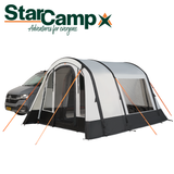 Dorema StarCamp Voyager Air driveaway awning set up beside a camper van in a scenic outdoor setting.